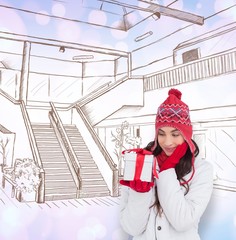 Poster - Content brunette in winter clothes holding gift
