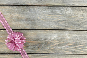 Wall Mural - Old wooden background with beautiful bow