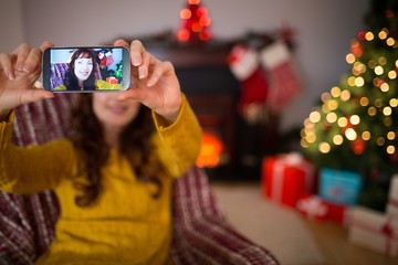 Beauty redhead taking a selfie at christmas