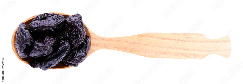 Wooden spoon of prunes isolated on white