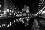 Fototapeta  - Buildings reflecting in the water at night in the Inner Harbor o