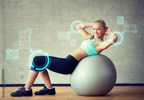 Nowoczesny obraz na płótnie smiling woman with exercise ball in gym