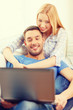 © Syda Productions - smiling happy couple with laptop at home