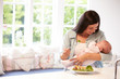 © Monkey Business - Mother With Baby Eating Healthy Meal In Kitchen