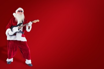 Poster - Composite image of santa claus plays guitar with sunglasses