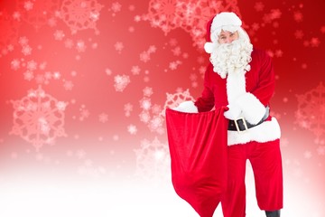 Poster - Composite image of smiling santa claus opening sack