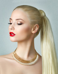 Beauty portrait of gorgeous blonde woman with ponytail