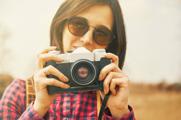 Sticker - Traveler woman takes photographs with vintage photo camera