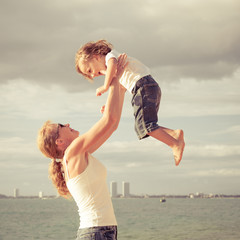 mother and  son playing on the beach