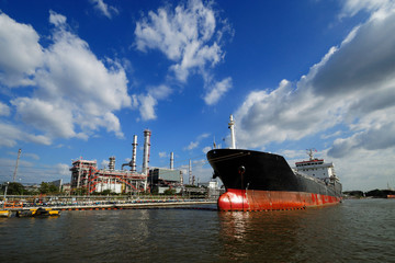 large tanker ship oil transport, a marine barge with container is in refinery port. this dock termin