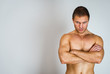 © M-Production - Muscular male model with arms folded. Place for text.