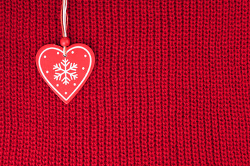 background of wool knitted fabric with heart decoration