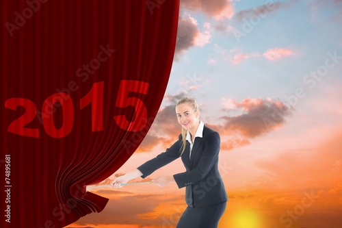 Fotografía Composite image of businesswoman pulling a rope