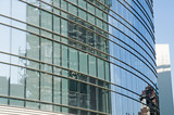 Glass Facade of company building with reflection of blue sky.