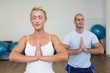 © WavebreakMediaMicro - Couple with joined hands and eyes closed at fitness studio