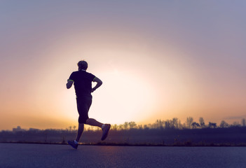 Running man silhouette in sunset time