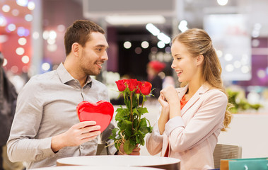 Wall Mural - happy couple with present and flowers in mall