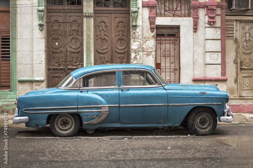 Fototapeta na wymiar Blue car in Havana on a rainy day