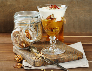 Canvas Print - Tasty dessert with oat flakes and honey, on table