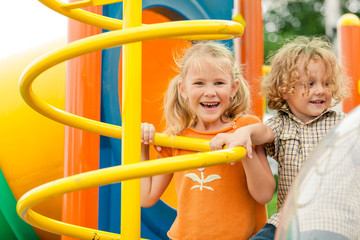 Wall Mural - Two happy children on the playground