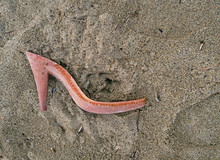 Pollution Or Drowned - Plastic Female Shoe Remains On Beach