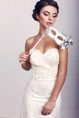 Poster - beautiful girl wearing elegant dress,holding a mask in hand