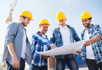 Poster - group of builders with tablet pc and blueprint