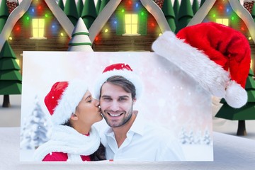 Poster - Composite image of festive young couple holding gift