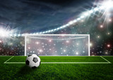 Fototapeta Sport - Soccer ball on green stadium arena