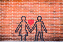 Couple In Love Sprayed Paint On Red Brick Wall