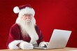 © WavebreakMediaMicro - Composite image of santa pays with credit card on a laptop