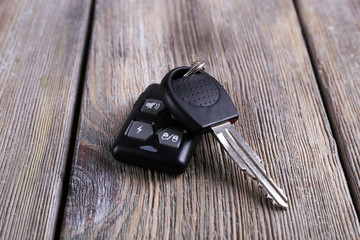 Wall Mural - Car key with remote control on wooden table, close-up