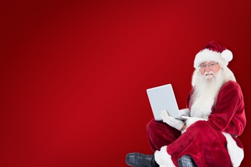 Aufkleber - Composite image of santa sits and uses a laptop