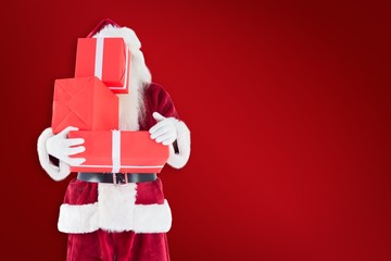 Poster - Composite image of santa covers his face with presents