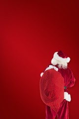 Aufkleber - Composite image of santa is holding his bag in one hand