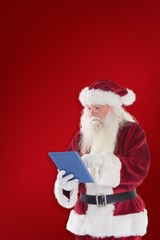 Aufkleber - Composite image of santa uses a tablet pc