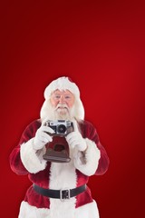 Poster - Composite image of santa is taking a picture