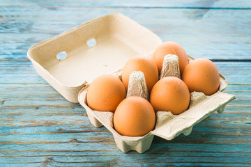 Wall Mural - eggs pack on wood background