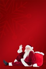 Poster - Composite image of santa sits leaned on his bag and waves