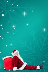 Poster - Composite image of santa sits leaned on his bag