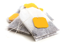 Tagged Teabags With String On White Surface.