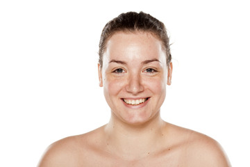 Wall Mural - smiling young woman without makeup on white background