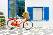 The Decoration Of Vintage Orange Bicycle And White Building