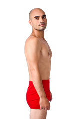 Wall Mural - Portrait of a fit athletic man in red underwear isolated.