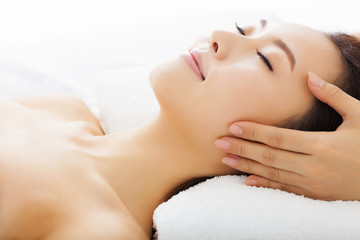 massage of face for woman in spa salon