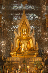 gold buddha statue in church at buddhist temple in Thailand