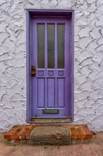 Purple Door With Worn Rug