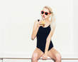 © Kaponia Aliaksei - sporty blonde girl in red sunglasses with cocktail