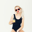 © Kaponia Aliaksei - portrait of pretty blonde woman in sunglasses with cocktail