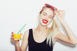 © Kaponia Aliaksei - Pretty smiling blonde woman in sunglasses with cocktail